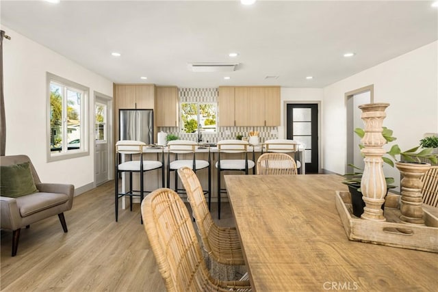 dining room featuring light wood-style flooring and recessed lighting