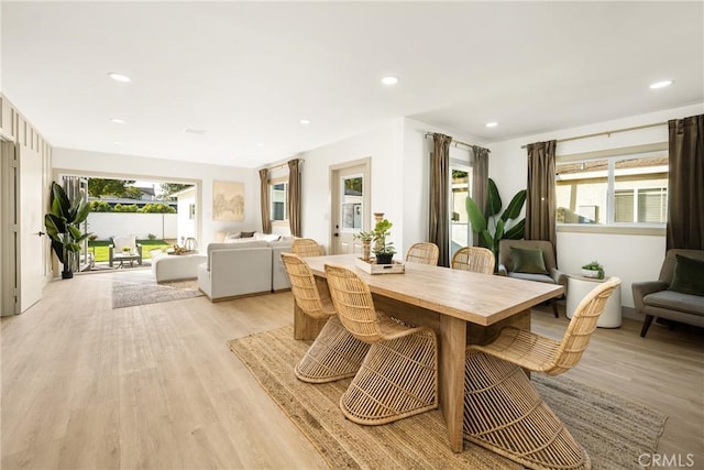 dining room with light wood-style flooring, a wealth of natural light, and recessed lighting