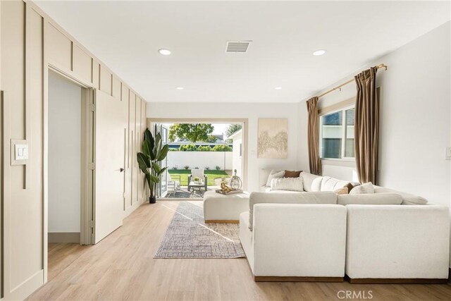 living area featuring light wood-style flooring, visible vents, and recessed lighting