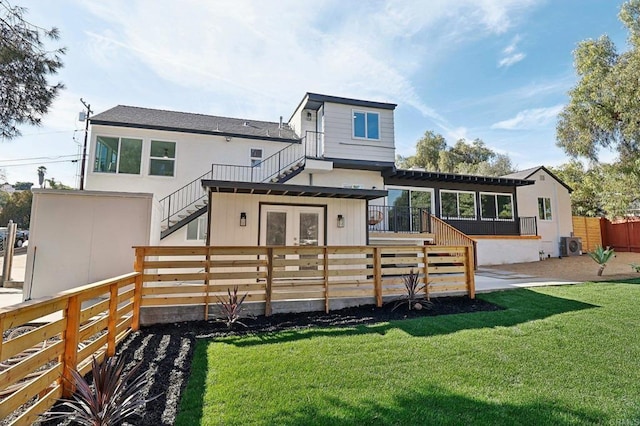 rear view of property with a lawn and french doors