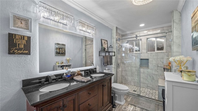 bathroom with vanity, toilet, ornamental molding, and walk in shower