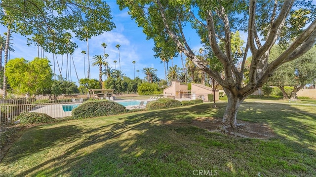 view of yard with a fenced in pool