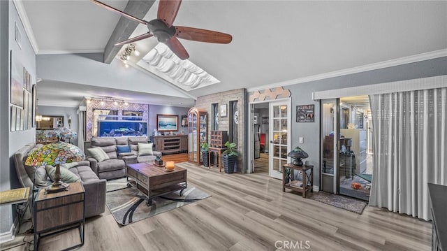 living room featuring ceiling fan, light hardwood / wood-style flooring, lofted ceiling with beams, and ornamental molding