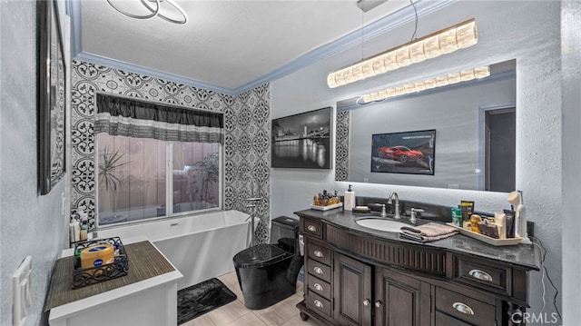 bathroom with toilet, vanity, tile patterned flooring, ornamental molding, and a textured ceiling