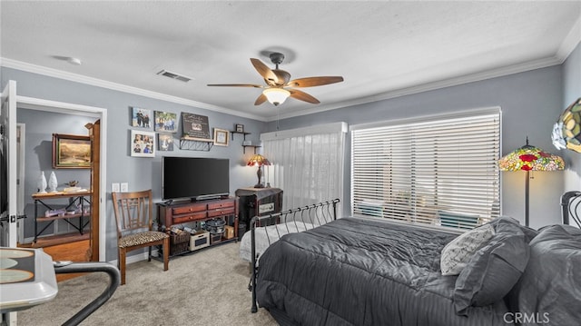 carpeted bedroom featuring ceiling fan and ornamental molding