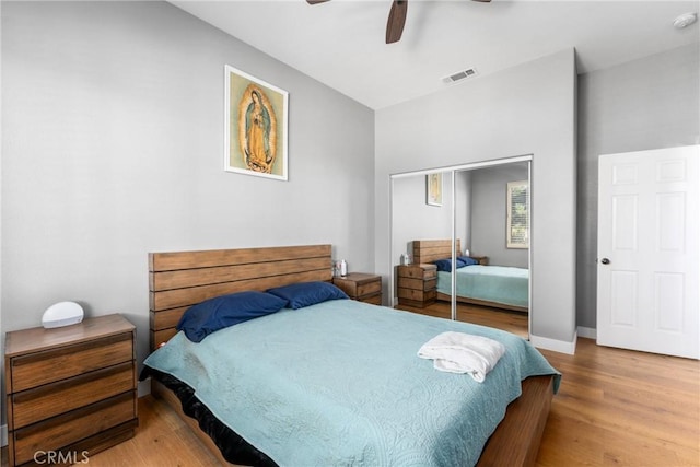 bedroom featuring ceiling fan, a closet, and hardwood / wood-style floors