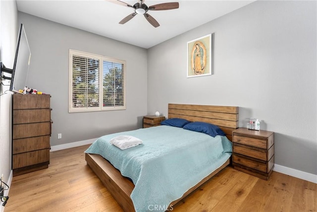 bedroom with ceiling fan and light hardwood / wood-style flooring