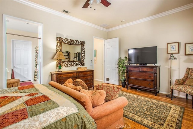 bedroom featuring ceiling fan, crown molding, and hardwood / wood-style floors