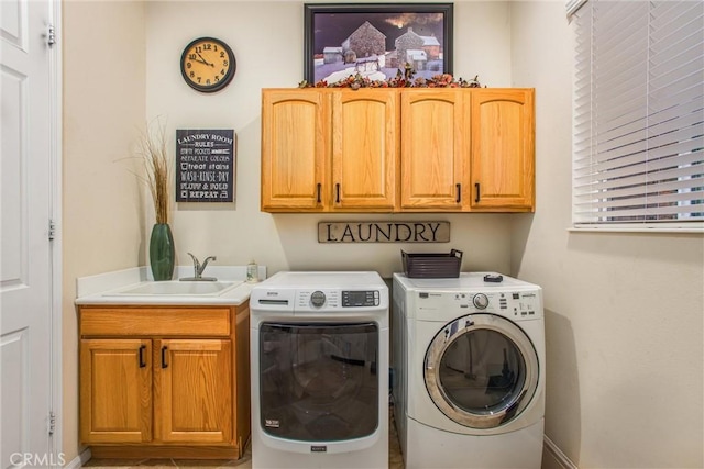 washroom with cabinets, sink, and washing machine and clothes dryer