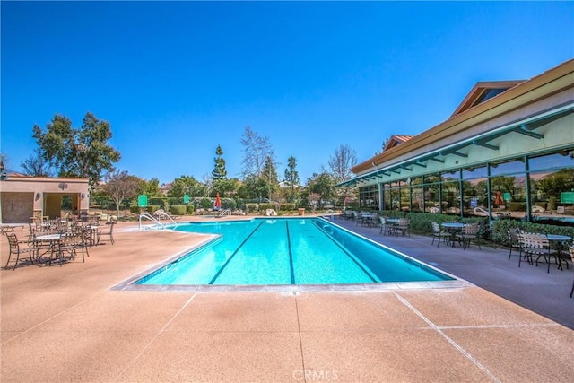 view of swimming pool featuring a patio area