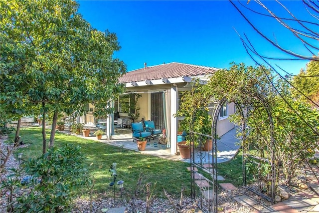 back of house with a yard and a patio