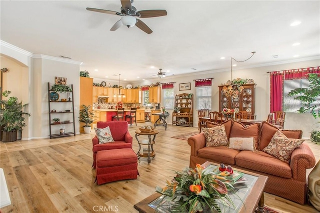 living room featuring ceiling fan, a healthy amount of sunlight, and light hardwood / wood-style floors