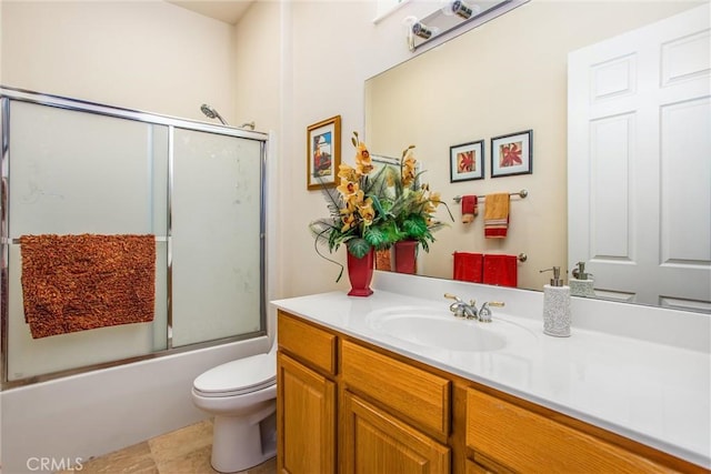 full bathroom featuring toilet, enclosed tub / shower combo, and vanity