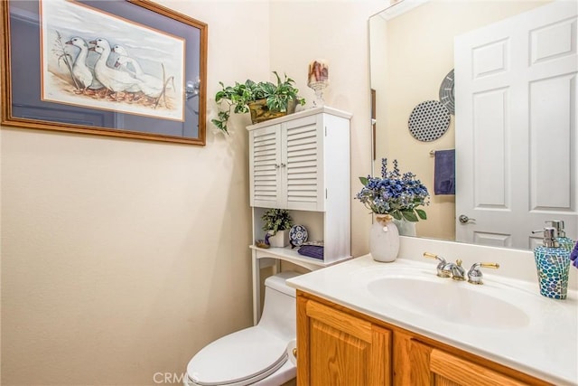 bathroom with toilet and vanity