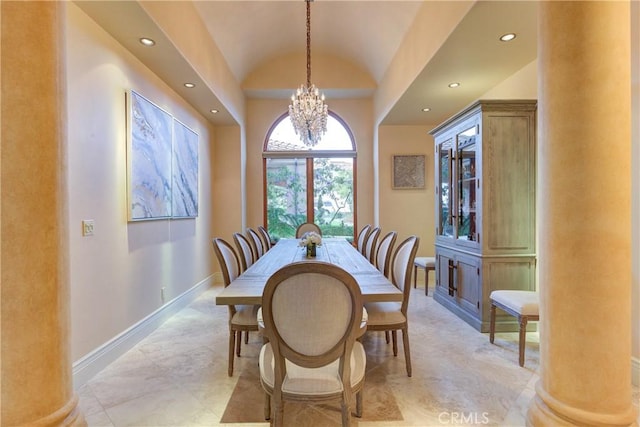 dining room featuring vaulted ceiling, a chandelier, and decorative columns