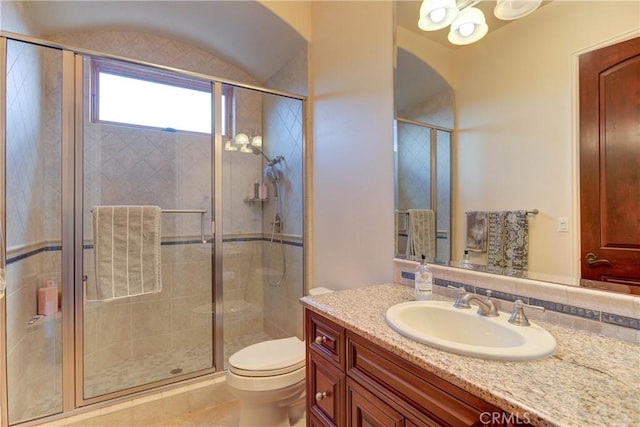 bathroom featuring tasteful backsplash, vanity, an enclosed shower, and toilet