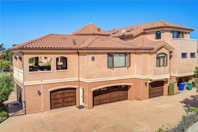 mediterranean / spanish home featuring a garage