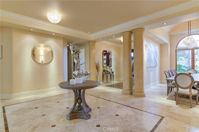 entrance foyer with decorative columns and ornamental molding