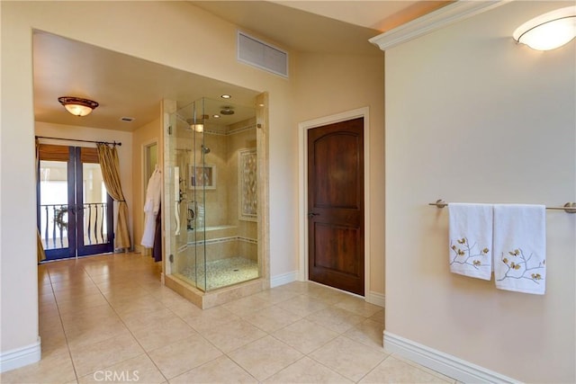 bathroom with an enclosed shower, french doors, and tile patterned floors