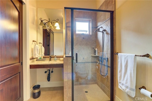 bathroom with toilet, tile patterned floors, walk in shower, and sink