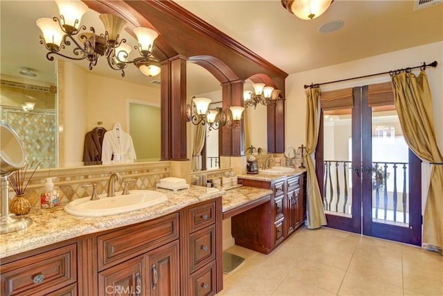 bathroom with tile patterned flooring, french doors, and vanity