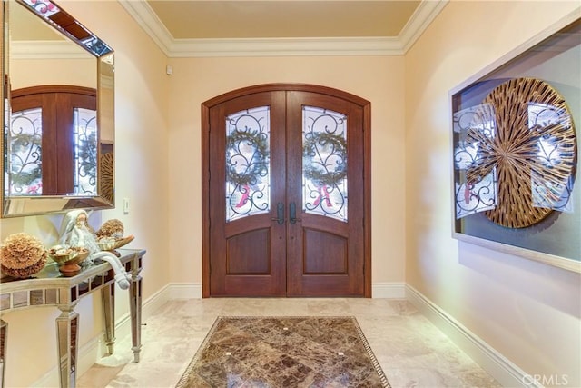 entryway with crown molding and french doors