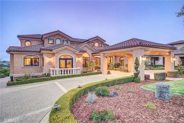 mediterranean / spanish-style home with french doors