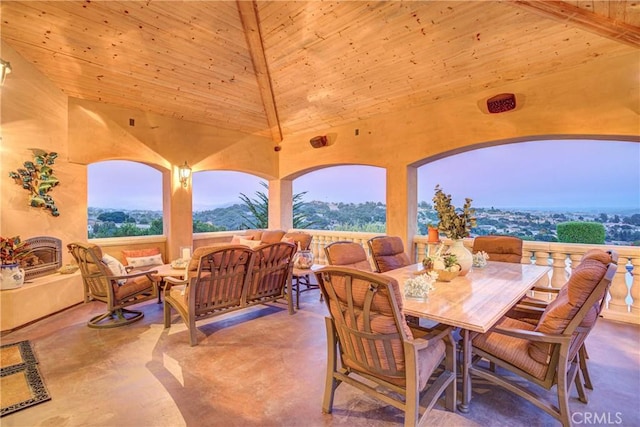 patio terrace at dusk with an outdoor living space with a fireplace