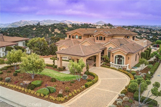 mediterranean / spanish house featuring a mountain view