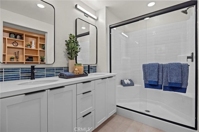 bathroom with an enclosed shower, vanity, and tasteful backsplash