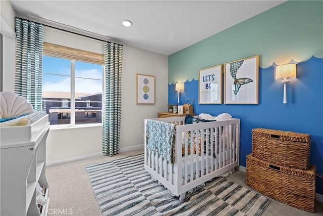 bedroom with carpet flooring and a nursery area