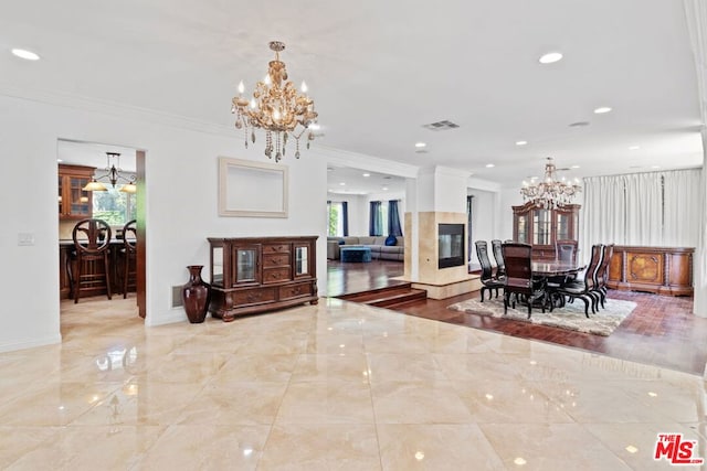 dining area with a fireplace and ornamental molding