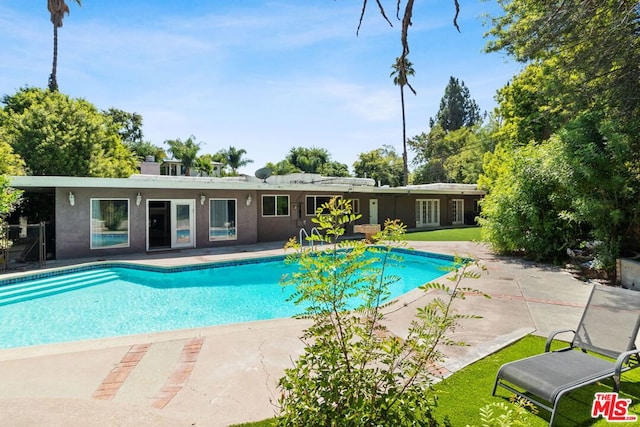 view of swimming pool with a patio