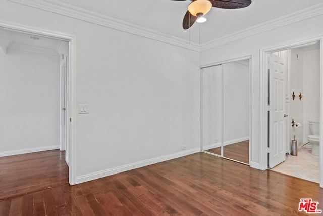 unfurnished bedroom featuring ceiling fan, hardwood / wood-style floors, ensuite bathroom, and ornamental molding