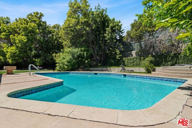 view of swimming pool featuring a patio area