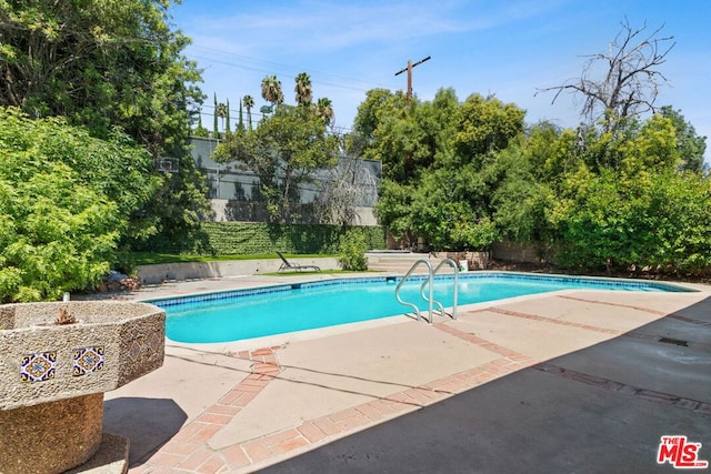 view of pool featuring a patio