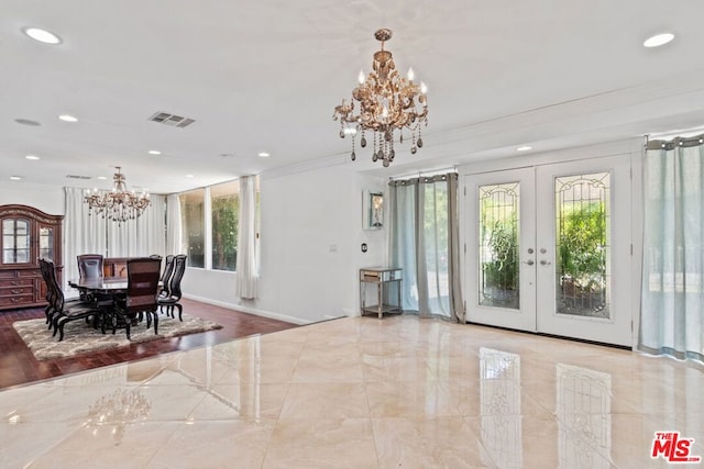 dining area featuring french doors, a notable chandelier, and ornamental molding