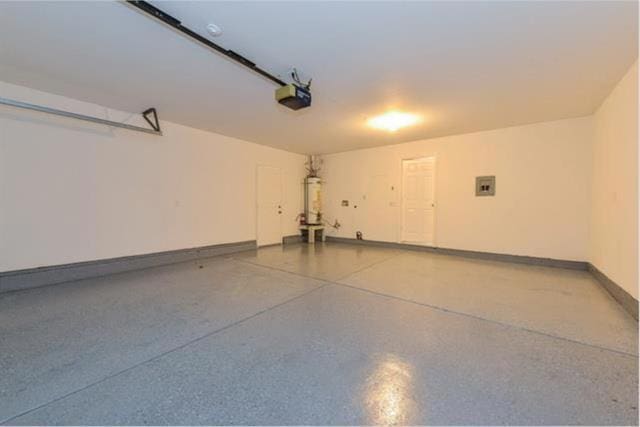 garage featuring a garage door opener, electric panel, and gas water heater