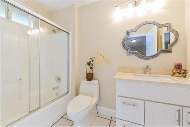 full bathroom featuring toilet, tile patterned floors, vanity, and enclosed tub / shower combo