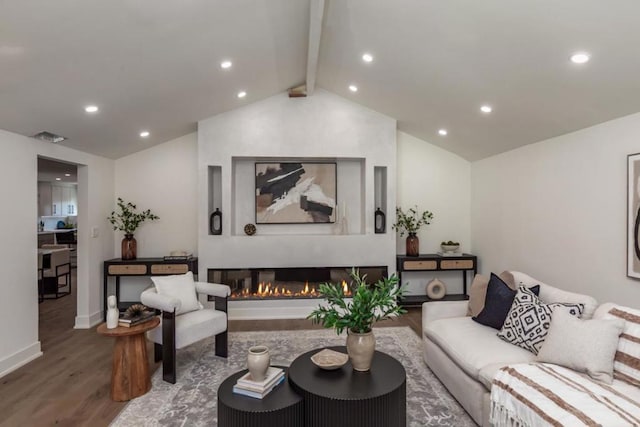 living room featuring lofted ceiling with beams and wood-type flooring