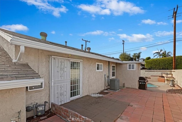 rear view of house featuring a patio area and central AC unit