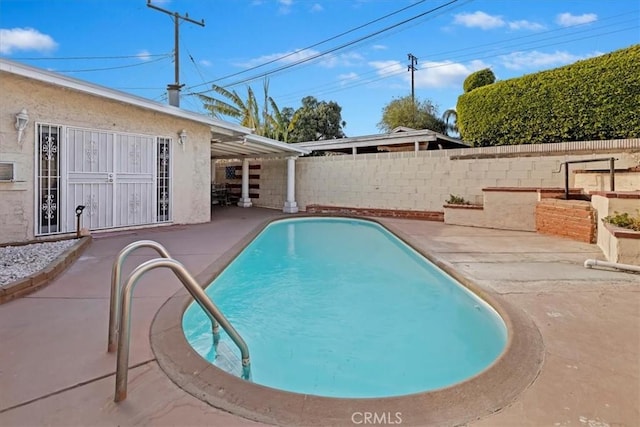 view of swimming pool with a patio area