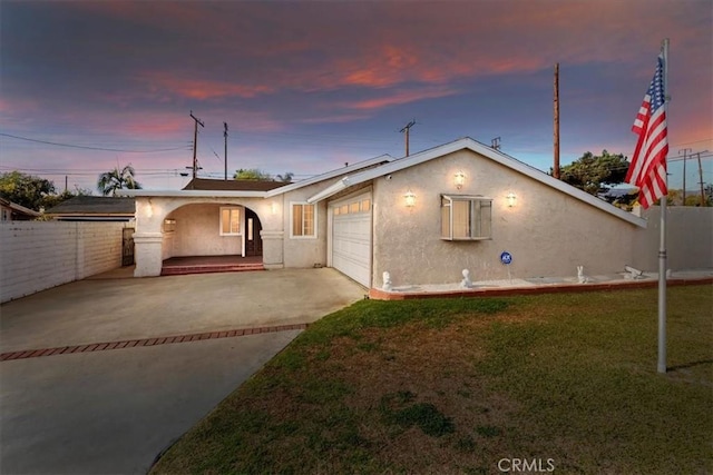 view of front of property with a garage and a yard