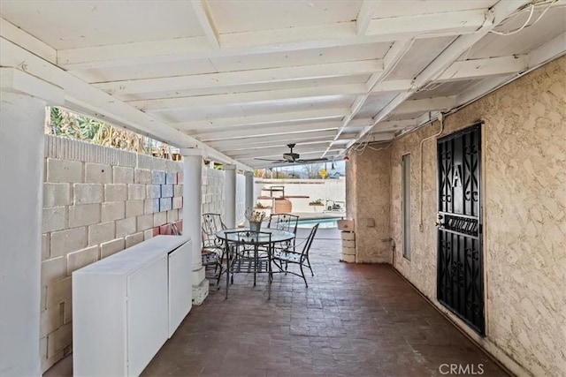 sunroom with ceiling fan and lofted ceiling