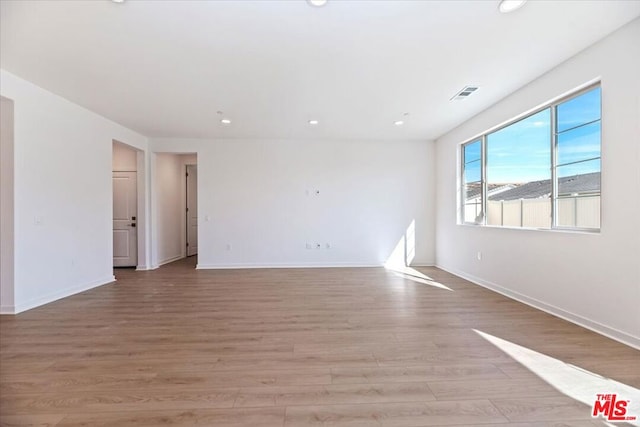 spare room with light hardwood / wood-style floors