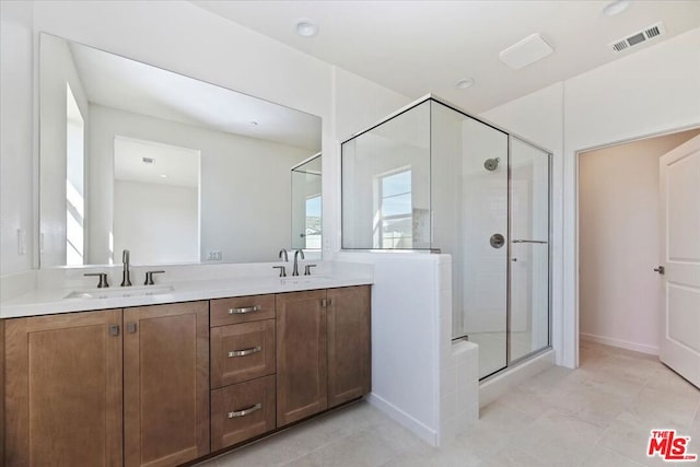 bathroom featuring vanity and a shower with shower door