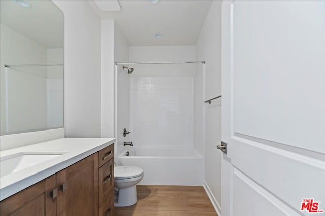 full bathroom with shower / tub combination, wood-type flooring, toilet, and vanity