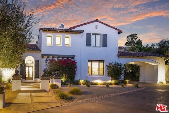 mediterranean / spanish house featuring a garage