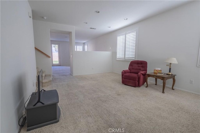 sitting room featuring light carpet and plenty of natural light