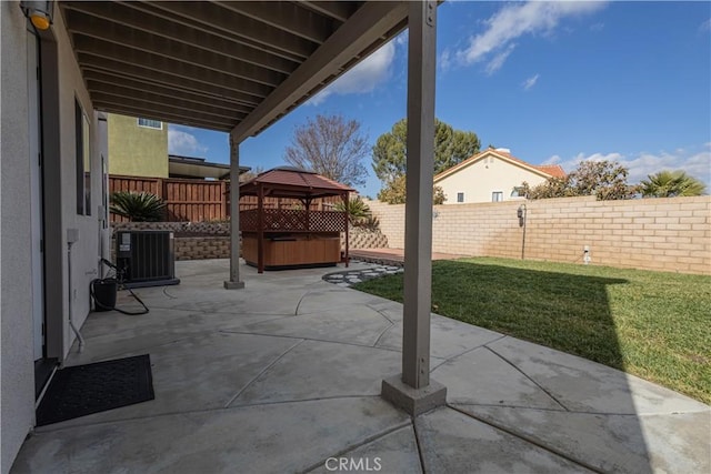 view of patio / terrace with a gazebo, a hot tub, and cooling unit